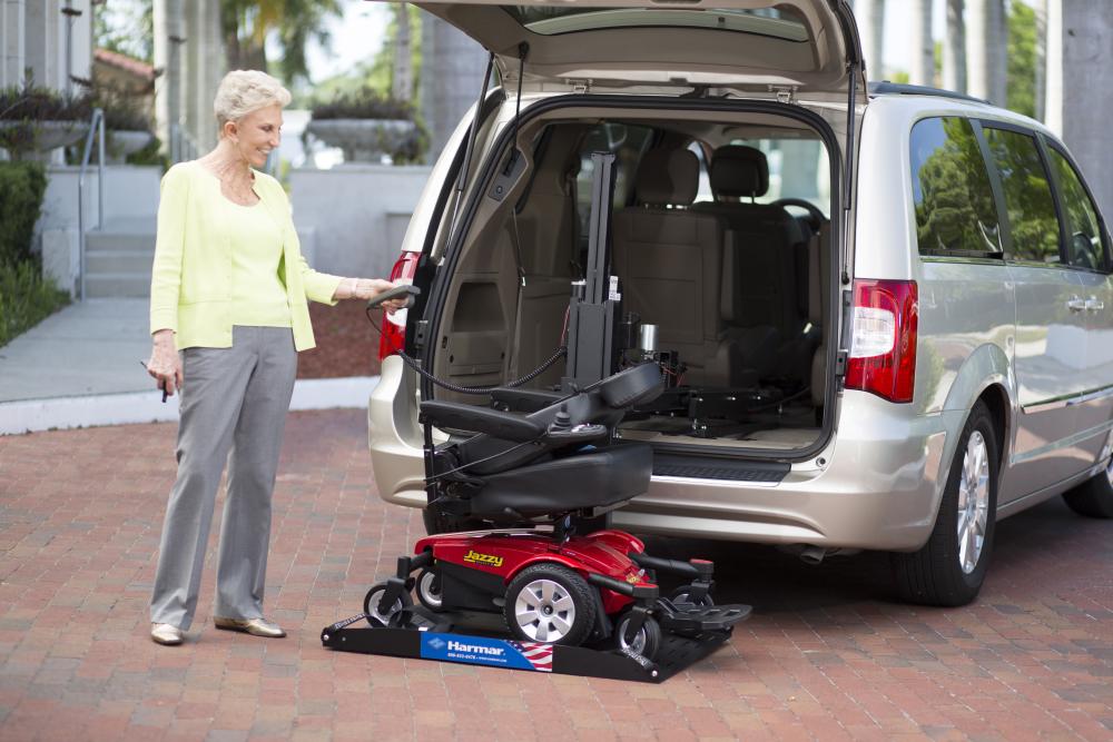 Harmar AL600 vehicle lift loading a power chair into a van
