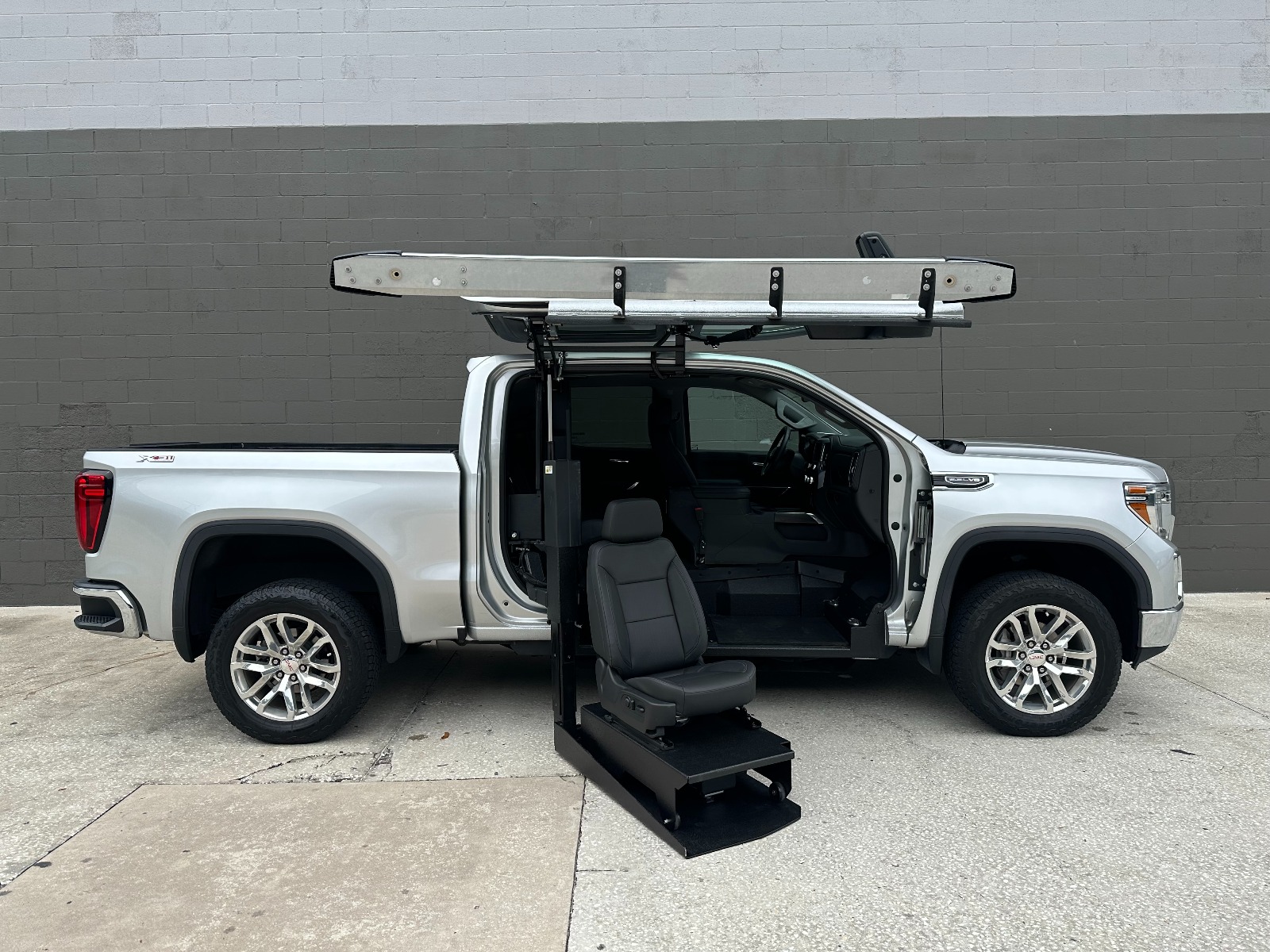 Silver Honday Odyssey wheelchair van with in floor ramp wheelchair van conversion deployed from open passenger sliding door.