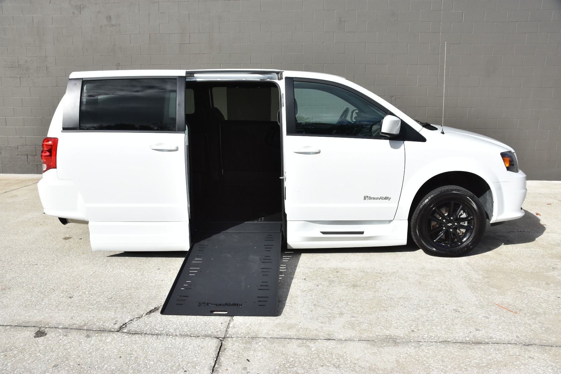 White 2020 Dodge Grand Caravan Wheelchair Van with ramp deployed, as seen from passenger side.