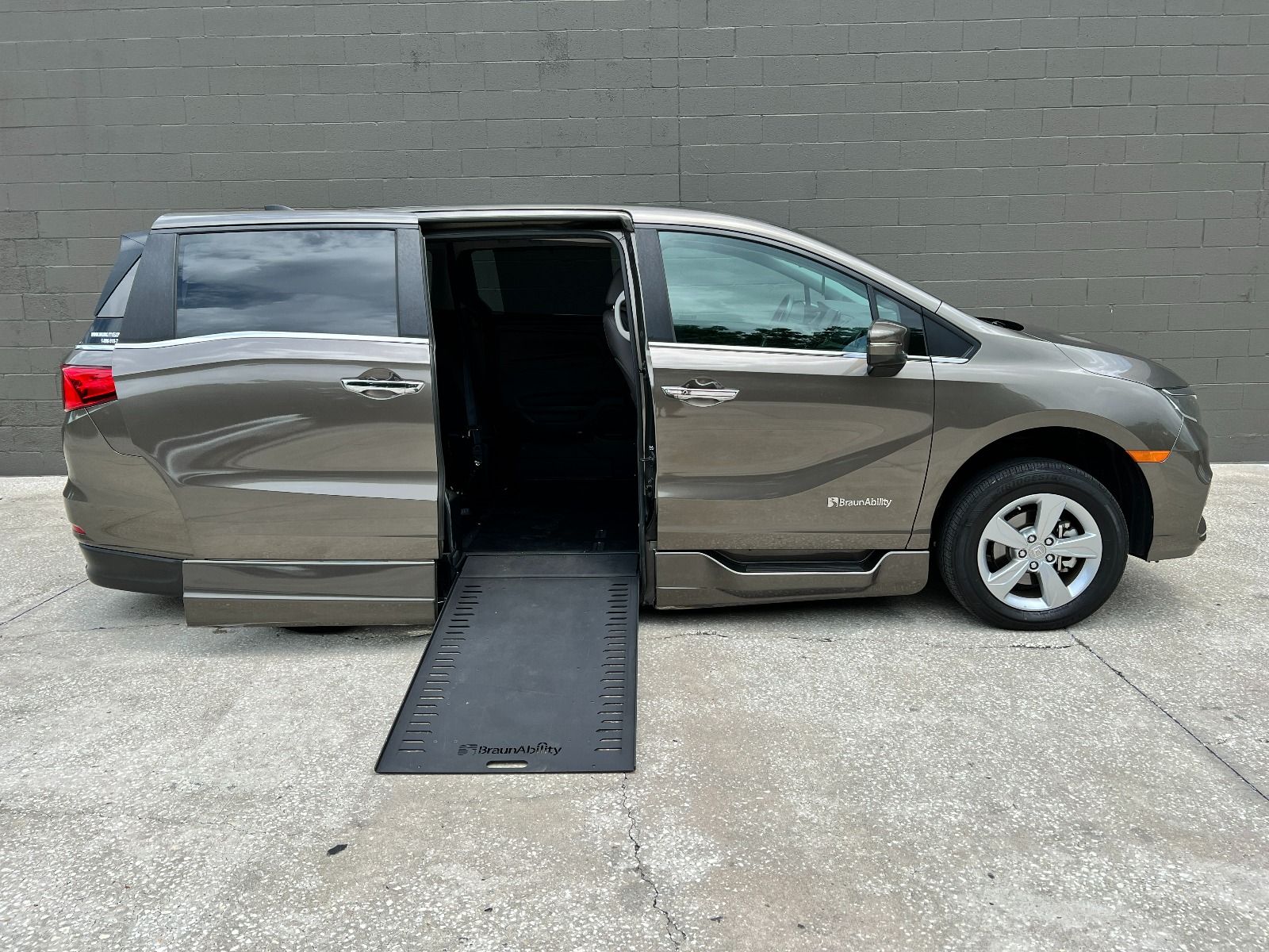 Gray 2019 Honda Odyssey Wheelchair Van with ramp deployed, as seen from passenger side.