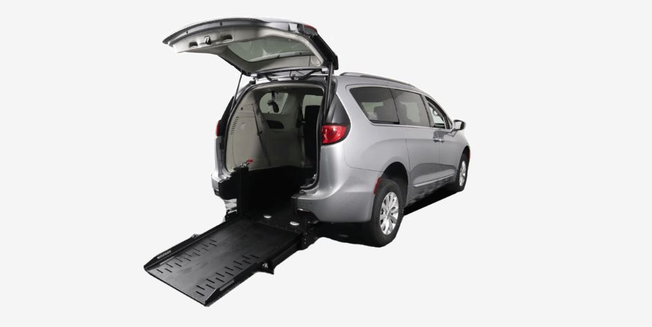 A Silver Chrysler Pacifica Wheelchair Van with AMS rear entry wheelchair van conversion with ramp deployed from rear hatch.