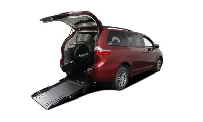 A red Toyota Sienna with AMS rear entry ramp conversion with the ramp deployed from the rear hatch.