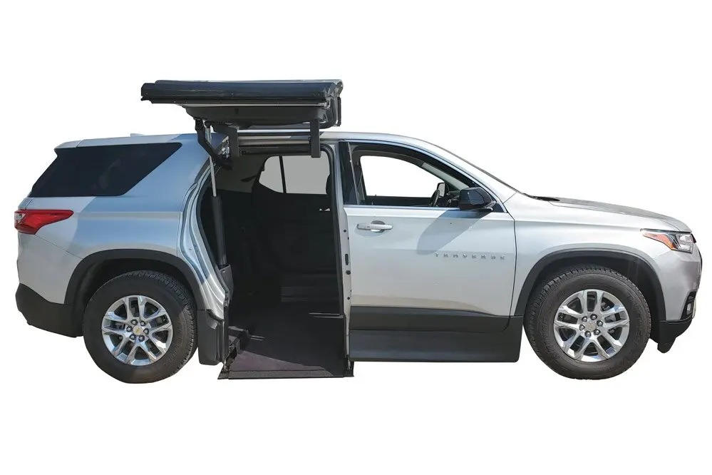 ATC Conversions Chevrolet Traverse wheelchair accessible SUV with ramp deployed from passenger side.