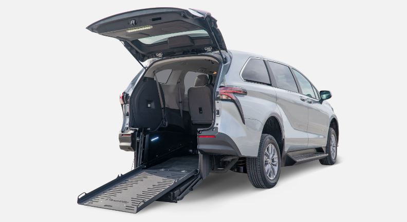 A Silver Toyota Sienna with BraunAbility Rear Entry Conversion with ramp deployed from rear hatch of vehicle.