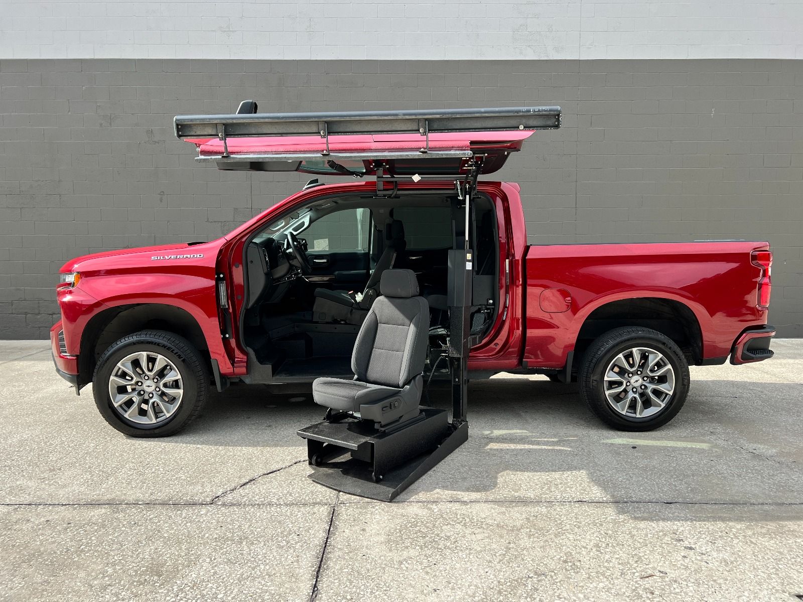 Chevrolet Silverado Wheelchair Accessible Truck with lift deployed from driver side doors.