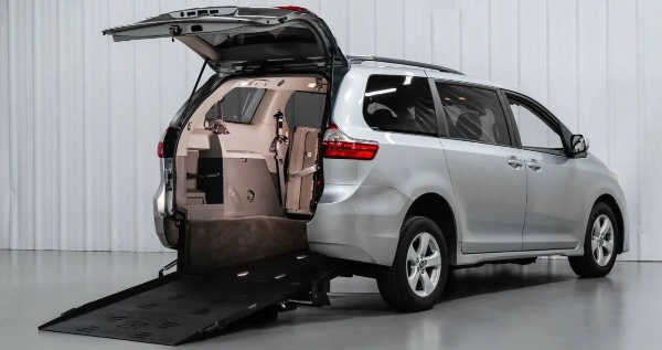 FMI Conversions Toyota Sienna with manual rear entry conversion with ramp deployed from rear hatch.