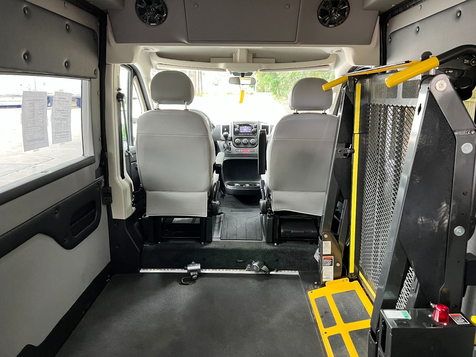 Interior showing lift and back of front seats of Ram ProMaster Full Size Wheelchair Van with Tempest X-HT Conversion