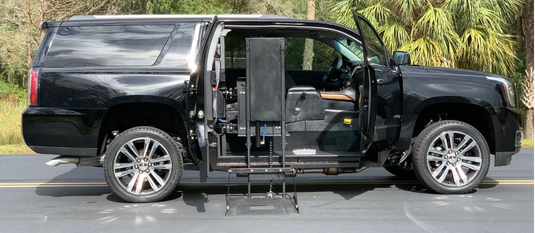 GMC Yukon equipped with Ryno SUV conversion with lift deployed from passenger side doors.