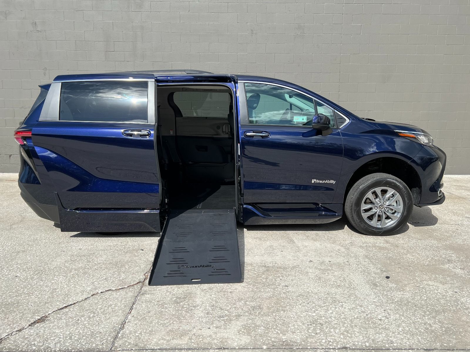 Toyota Sienna Hybrid Wheelchair van with sliding door open and ramp deployed