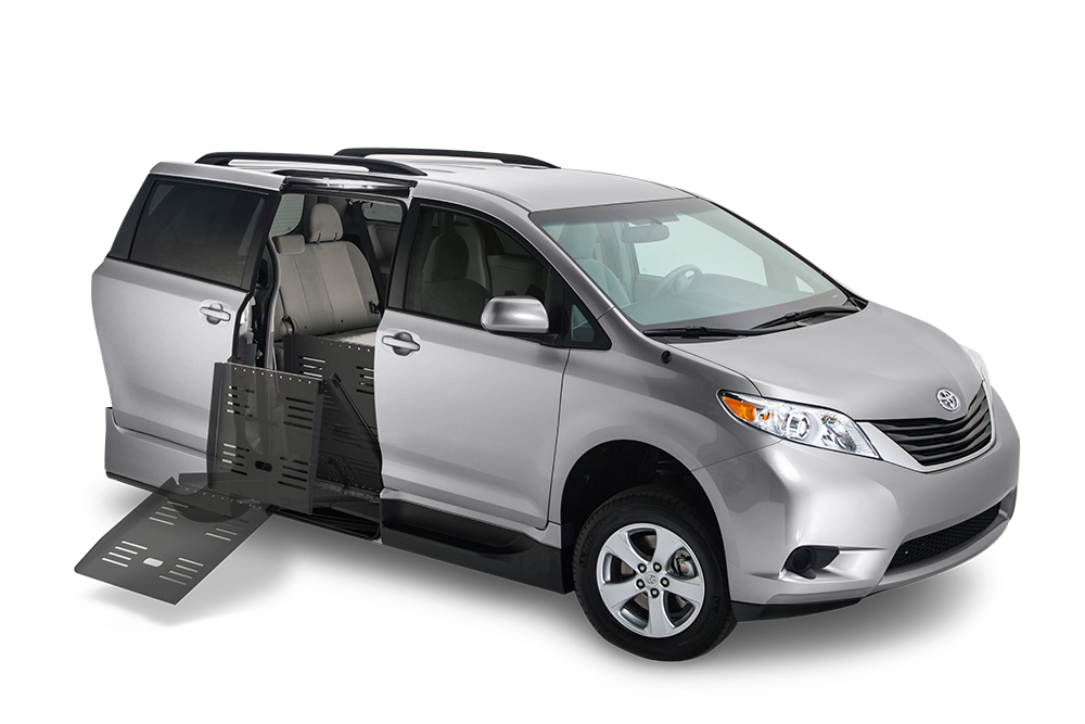 A Silver Toyota Sienna with VMI Summit folding ramp conversion with the ramp deployed from the passenger sliding doorway.
